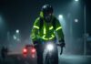 Night cycling safety tips with cyclist using lights, reflective gear, and protective equipment on well-lit city roads