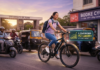 College student riding a Hero Lectro e-cycle on a Pune city road while commuting to campus efficiently and sustainably.